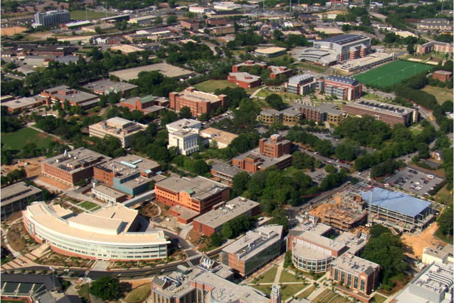 Aerial view of a multi-building university campus, with academic, research, and athletic facilities connected by roads and walkways.